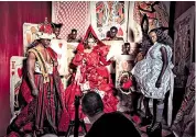  ??  ?? Star-studded: left, Djimon Hounsou and Rupaul as the King and Queen of Hearts with Duckie Thot as Alice; main picture, Tim Walker shooting Lupita Nyong’o as the dormouse; above right, Sean Combs and Naomi Campbell as beheaders; all styled by Vogue’s...