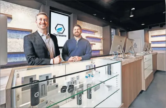  ?? [ERIC ALBRECHT/DISPATCH PHOTOS] ?? Craig Maurer, left, and Todd Yaross, two of the co-owners of the Terrasana dispensary, prepare their store on Grandview Avenue for a Tuesday opening.