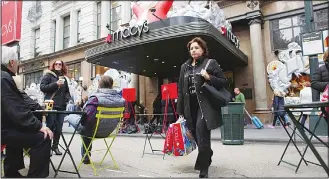  ??  ?? This file photo taken on Nov 25, 2016 shows a shopper leaving Macy’s department store in New York. US retail sales edged upwards as the holiday season approached in November but were significan­tly slower than in prior month, the Commerce Department...