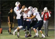  ?? RECORDER PHOTO BY CHIEKO HARA ?? Strathmore High School's Amando Rodriguez, center, celebrates with his teammates after scoring a touchdown Friday at Frank Skadan Stadium in Lindsay.