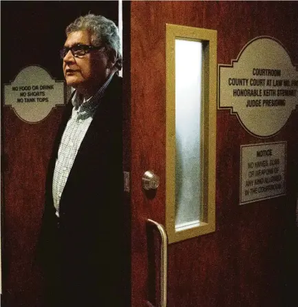  ?? Jason Fochtman / Staff photograph­er ?? Manuel La Rosa-Lopez, a former priest at Conroe’s Sacred Heart Catholic Church, leaves the courtroom after his case was delayed until Jan. 10. La Rosa-Lopez has been charged with four counts of indecency with a child years ago.