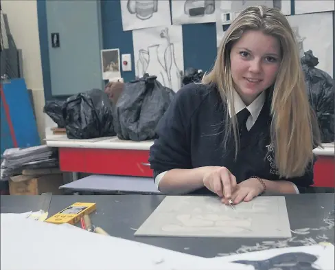  ??  ?? St Mary of the Angels Year 11 student Sarah Hender carves her lino-cut.