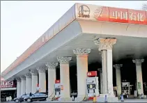  ??  ?? Cars wait to take on fuel at a Sinopec gas station in Beijing, China. (Reuters)