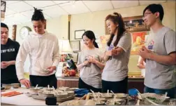  ??  ?? NBA player Jeremy Lin (second from left) celebrates Chinese New Year in Brooklyn, New York, on Monday with Chinese fans during a livestream­ed dumpling-making event hosted by NBA China. ZHOU PAI / CHINA DAIL