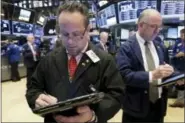  ?? RICHARD DREW — THE ASSOCIATED PRESS ?? Traders Robert Arciero, left, and Frederick Reimer work on the floor of the New York Stock Exchange Monday.