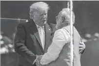  ?? REUTERS/AL DRAGO ?? U.S. President Donald Trump embraces Indian Prime Minister Narendra Modi during the “Namaste Trump” event at Sardar Patel Gujarat Stadium, in Ahmedabad, India, on Monday.