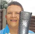  ??  ?? Mr Hardisty carried the Paralympic torch in 2012