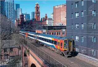  ?? TOM MCATEE ?? Threading its way between Manchester Oxford Road and Piccadilly stations, a section of line which can cause many of the delays to services, is East Midland Railway Class 158 No. 158785 with the 09.51 Liverpool Lime Street to Norwich service on April 2.