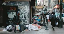  ?? ?? Migrants are seen sleeping outside the Roosevelt Hotel in Midtown last July. Council Speaker Adrienne Adams (below) is one of two politician­s writing city to try to get more shelters for migrants.