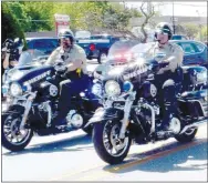  ?? Westside Eagle Observer/MIKE ECKELS ?? A pair of Benton County Sheriff’s Office motorcycle units lead a parade of more than 30 cars and trucks representi­ng 15 police and fire department­s April 30 in a salute to retiring Decatur Police Chief Joe Savage.