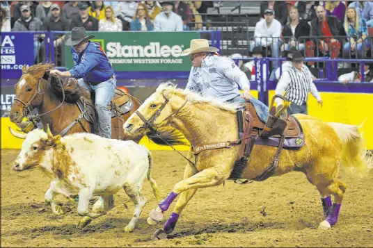  ?? Erik Verduzco
Las Vegas Review-journal ?? Hunter Cure, right, competes Saturday during the steer wrestling event in the National Finals Rodeo at the Thomas & Mack Center. He started the NFR in fifth place, but Friday’s victory added $28,913 to his bottom line.