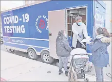  ??  ?? A medical worker stands outside of a mobile Covid-19 testing lab in Brooklyn as the city begins to run low on the vaccine doses in New York City. — AFP photo