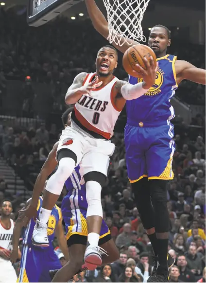  ?? Steve Dykes / Associated Press ?? In a January game, Portland guard Damian Lillard is unafraid to take the ball to the basket against Kevin Durant.