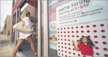  ??  ?? A help wanted sign hangs on the door of a Target store in Uniontown, Pa., on Sept. 2.