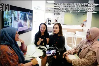  ?? ?? Nancie Foo (second right) and Dr Wendy Wong (second left) interviewe­d by Malaysian journalist­s at the Marche du Film in Cannes, Perancis. — Bernama photo