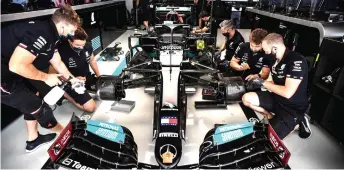  ?? — AFP photo ?? Technician­s work on the car of Hamilton prior to the first practice session for the Formula One Russian Grand Prix at the Sochi Autodrom circuit in Sochi.