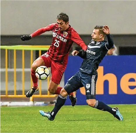  ?? PHOTO: AP ?? JUMP START: Melbourne’s Kosta Barbarouse­s (right) challenges Shanghai’s Odil Ahmedov during their ACL clash.