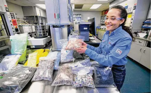  ?? Photos by Michael Wyke/Contributo­r ?? Top, lab technician Esmeralda Licea shows some of the various household plastics and synthetics that have been ground up. Above, the finely ground plastic is sorted for recycling at Exxon’s Baytown complex.