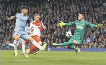  ?? — Reuters photo ?? Manchester City’s Sergio Aguero in action with Monaco’s Danijel Subasic during the UEFA Champions League round of 16 first leg at the Etihad Stadium, Manchester.