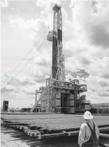  ?? Michael Ciaglo / Houston Chronicle file ?? A rig sits on a pad site where it will drill three to six wells next to each other at a Chevron site in the Midland area.