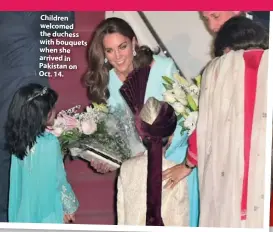  ??  ?? Children welcomed the duchess with bouquets when she arrived in Pakistan on Oct. 14.