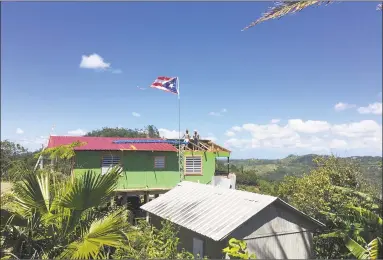  ?? Sarah Varney / TNS ?? In the aftermath of Hurricane Maria, restoratio­ns are being made to a roof in Castaner, a village in Puerto Rico's central mountains. But recovery is slow.