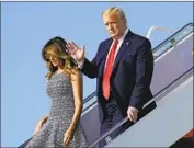  ?? Evan Vucci Associated Press ?? PRESIDENT TRUMP, with wife Melania, threatened Twitter after it added informatio­nal links to his tweets that said mail-in voting would lead to fraud.