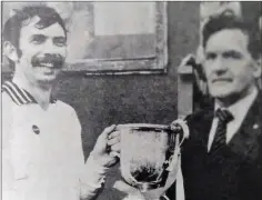  ??  ?? Peter Burke is presented with the Miley Cup by Pat Murphy after the final of 1982.