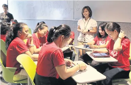  ??  ?? Domestic helpers learn how to use Google in a training course offered by HOME, a migrant shelter and counsellin­g centre in Singapore.