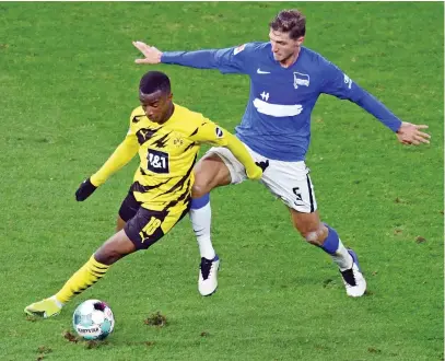  ?? Reuters ?? Borussia Dortmund’s Youssoufa Moukoko, left, in action with Hertha Berlin’s Niklas Stark during their Bundesliga match on Saturday. Dortmund won 5-2.