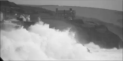  ?? AP PHOTO/ALASTAIR GRANT ?? Powerful waves break on the shoreline around the small port of Porthleven, south west England, on Sunday.