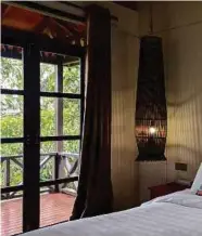  ??  ?? Each chalet at the Sepilok Forest Edge Resort are uniquely decorated with ethnic-inspired linens and decoration­s, such as the lamp cover made out of traditiona­l bubu (fishing trap).