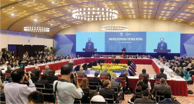  ?? — AFP photos ?? HANOI: Vietnam’s Prime Minister Nguyen Xuan Phuc delivers a speech at the Asia-Pacific Economic Cooperatio­n (APEC) 23rd Ministers responsibl­e for Trade Meeting at the National Convention Center in Hanoi yesterday.
