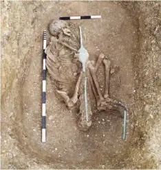  ??  ?? Left and below: A “speared-corpse” burial at The Mile; a young man had been buried in a deep pit within a circular ditch, with five spears and a shield with a metal rib and boss (large scale 1m)