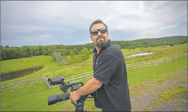  ?? (AP/Robert Bumsted) ?? Rowe uses his video camera near his home/