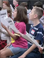  ?? SUBMITTED ?? Chardon Middle School fifth-grade students Keelie Hagan and SJ Moore give their all as they sing during an Ohio Music Education Associatio­n All-State Children’s Chorus regional rehearsal at Nordonia High School on Dec. 16. Together with CMS fourth-grade students Abran Gonzales, Nate Latessa, Charlotte Polak and Zoe Williams, the students advanced to the OMEA Profession­al Developmen­t Conference in Columbus on Feb. 1.