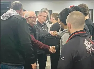  ?? Daniel Bereznicki/McDonald County Press ?? School board members shake hands with members of the MCHS wrestling team for their success in this year’s competitio­ns.