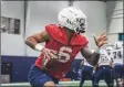  ?? Brendan Hill/UConn / Contribute­d photo ?? UConn quarterbac­k Ta’Quan Roberson participat­es in practice Thursday.