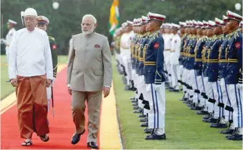  ?? — Reuters ?? Myanmar’s President Htin Kyaw and Prime Minister Narendra Modi inspect guard of honour in Presidenti­al Palace in Naypyitaw on Tuesday.