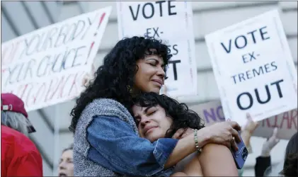  ?? JOSIE LEPE — THE ASSOCIATED PRESS ?? Mitzi Rivas, left, hugs her daughter Maya Iribarren during an abortion-rights protest at City Hall in San Francisco following the Supreme Court’s decision to overturn Roe v. Wade on Friday. The decision will set off a series of legal battles.