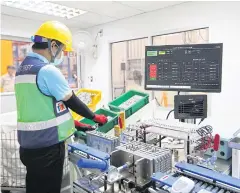  ??  ?? An engineer works at an auto parts facility in Chachoengs­ao province in the Eastern Economic Corridor. The EEC has seen a gradual increase in investment­s.