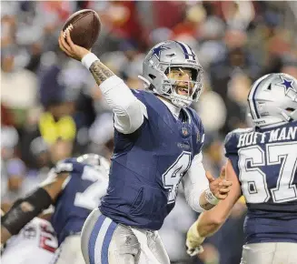  ?? Patrick Smith/Getty Images ?? The Dallas Cowboys’ Dak Prescott throws a pass during the second half against the Washington Commanders at FedExField last Sunday in Landover, Md.