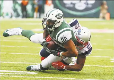  ?? Al Bello / Getty Images ?? Patriots strong safety Patrick Chung tackles Jets running back Matt Forte during the second half Sunday in East Rutherford, N.J.