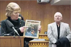  ?? Ted S. Warren Associated Press ?? SHERRY AND ROGER SHAVER, whose daughter was killed in 1996 by Dwayne Anthony Woods, protest Gov. Jay Inslee’s moratorium on executions in 2014.