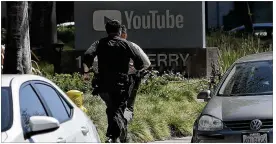  ?? JEFF CHIU / ASSOCIATED PRESS ?? Officers run toward a YouTube office Tuesday in San Bruno, Calif., as police and federal officials responded to a shooting at company headquarte­rs.