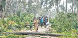  ?? PTI ?? A group of people relocates after Cyclone Titli hit Andhra Pradesh’s Srikakulam on Thursday. The 'very severe' cyclonic storm left eight people dead in the state. No deaths were reported from Odisha. The cyclone, with a wind speed of up to 150km/hour, uprooted trees and power installati­ons, and disrupted rail and road traffic. &gt;&gt; P10