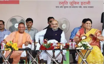  ??  ?? BJP president Amit Shah, Union minister Smriti Irani and UP chief minister Yogi Adityanath at public meeting in Amethi in October 2017.