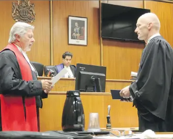  ?? MORGAN MODJESKI ?? Court of Queen’s Bench Chief Justice Martel D. Popescul, left, swears in veteran Saskatoon police officer Bruce Gordon, right, as a lawyer on Thursday in Saskatoon’s Court of Queen’s Bench. Judge Sanjeev Anand, centre, was present on behalf of the...