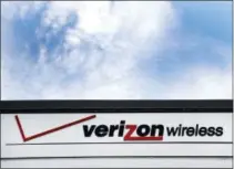  ?? ELISE AMENDOLA — THE ASSOCIATED PRESS FILE ?? This Monday file photo shows signage at a Verizon store, in North Andover, Mass. On Thursday Verizon announced its profit sunk 20 percent in its first quarter as it lost wireless customers. The New York company says it would have lost even more...