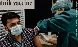  ??  ?? FRANTIC RUSH: A man gets a dose of the Sputnik V vaccine in Karachi on Monday (5)